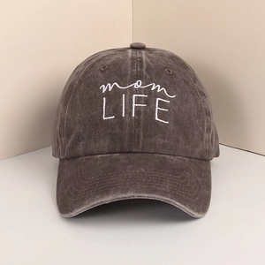 Detail of mom LIFE white embroidery on vintage washed dark grey cotton baseball cap