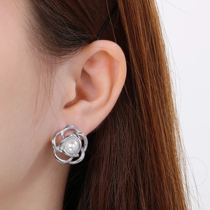 Close-up of camellia pearl stud earring in silver finish worn by a model