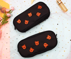 Close-up of black cute bear embroidery pencil case with zip closure and hanging loop