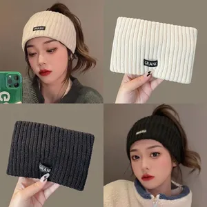 Knitted sports headband with GRANK letter label available in beige and black colors