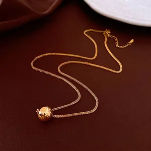 18K gold plated necklace featuring a textured spherical pendant with a minimalist design