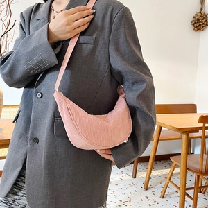 Pink corduroy crescent crossbody bag for women with adjustable strap on model