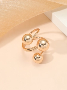 Detailed macro view of the triple gold balls on a layered adjustable ring