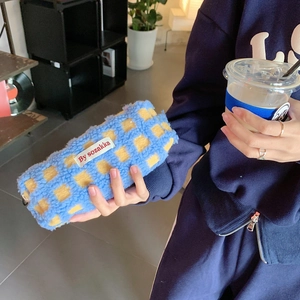 Detailed view of blue and yellow checkerboard sherpa fleece stationery pouch with side label