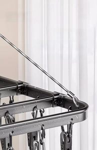 Macro shot of black aluminum drying rack showing waterproof texture and anti-slip clips