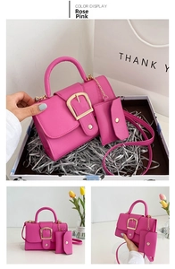 Detail view of rose pink crossbody handbag set with gold buckle and mini pouch