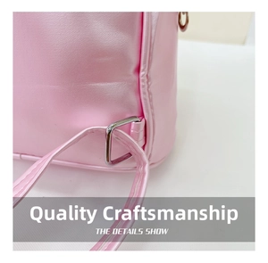 Close-up of pink mermaid backpack strap with reinforced stitching and silver metal buckle