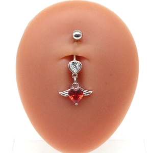 Detailed view of red heart zircon belly ring with angel wings on a silicone torso