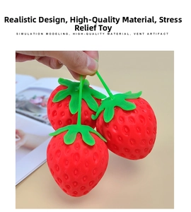 Three realistic strawberry squishy toys with green leaves being held in a hand