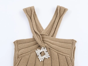 Detail of camel knit halter top featuring a square rhinestone buckle on the chest