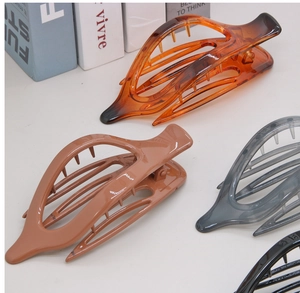 Detailed view of leaf-shaped hair claws in amber, brown, grey, and black plastic finishes