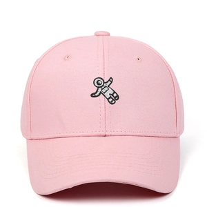 Detailed embroidery of an astronaut on a pink cotton baseball cap with fine stitching