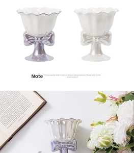Close-up of ceramic goblet featuring ruffle edges and a large decorative bow on the base