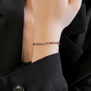 Minimalist geometric bracelet with purple oval zircon stones on a thin gold chain