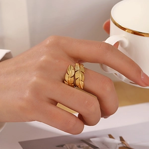 Adjustable gold plated stainless steel feather leaf ring for women on model hand