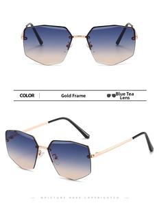 Close-up of frameless geometric sunglasses with gold metal temples and blue-brown gradient lenses