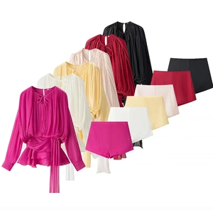 Detail of two-piece pleated ruffle top and shorts set in multiple vibrant colors