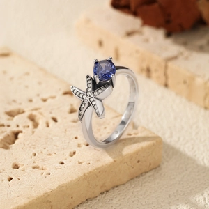 Elegant S925 sterling silver starfish ring with blue gemstone and white zircon accents