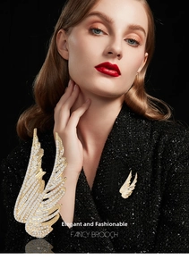 Close-up detail of luxurious gold-plated wing brooch with shimmering cubic zirconia stones