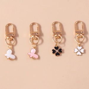 Set of four butterfly and clover enamel keychains with gold spring rings and rhinestones