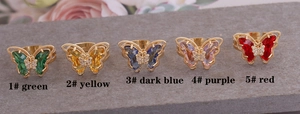 Macro shot of colorful zircon butterfly rings in gold finish with five vivid stone options