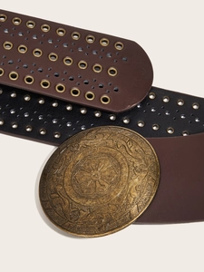 Detail of vintage PU leather belts with bronze floral round buckles and metal eyelets