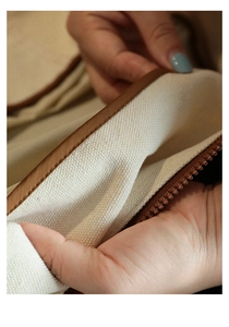 Close-up of canvas travel storage bag with coffee trim and high-quality zipper detail