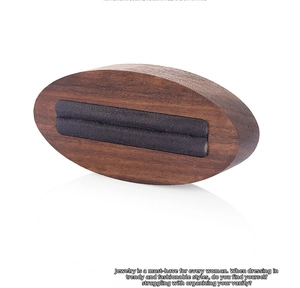 Macro view of walnut wood ring display stand with grey velvet double-row slots