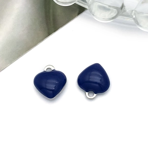 Detail of dark blue enamel heart charms with silver metal rings for DIY jewelry