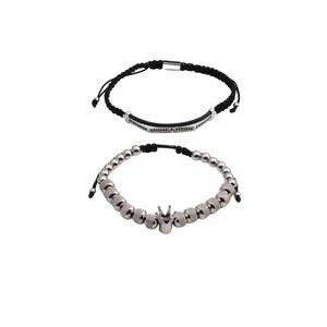 Dettaglio del set di bracciali con numeri romani, ciondolo a corona e cinturino nero