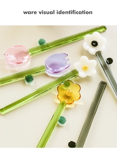 Detailed view of colorful glass flower stirrers in tulip and daisy shapes with long stems