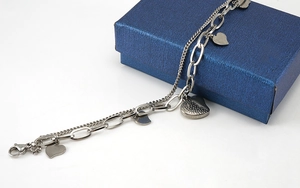 Close-up of double-layer stainless steel bracelet with heart charms and jewelry box