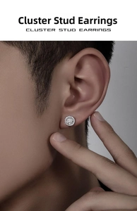 Macro side view of a round crystal cluster stud earring worn by a male model