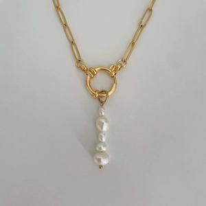 Detail of gold chain necklace featuring five irregular pearls with natural luster
