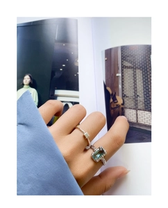 Close-up of S925 sterling silver ring featuring a rectangular emerald gemstone and texture