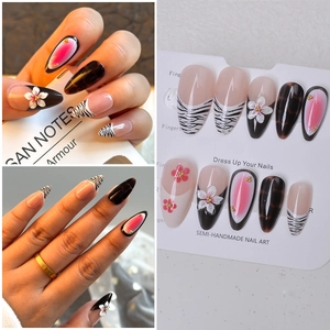 Detail of 3D floral press-on nails with zebra print and pink marble patterns
