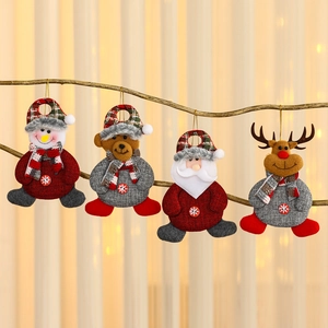 Set of four plush Christmas ornaments with Santa, snowman, and reindeer on a tree