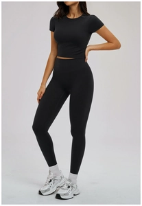 Detail view of the black two-piece sports set featuring high-waisted leggings and crop top