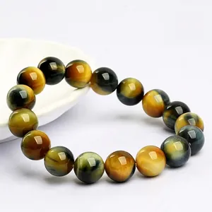 Natural yellow tiger eye beaded bracelet with cat eye effect on a white background