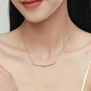 Elegant S925 silver necklace with star pendant and blue gems on model's neck