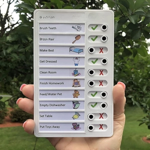 Close-up of portable chore checklist with sliding buttons for kids' daily habit tracking