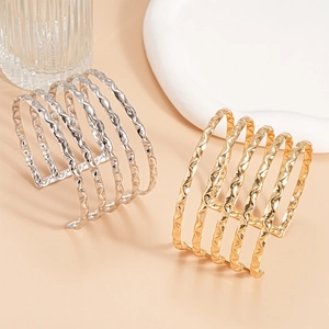Polished gold and silver textured multilayer open bangles with wavy metal patterns