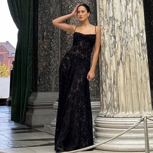 Detail of elegant black lace textures and slim fit silhouette on this evening gown