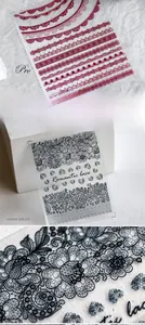 Detailed macro view of 5D embossed retro lace nail stickers in red and black romantic patterns