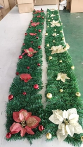 Detail of Christmas garlands with red and gold flowers for holiday store decorations
