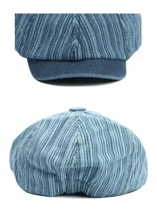 Detail of blue denim newsboy hat showing smooth curved brim and elastic back strap