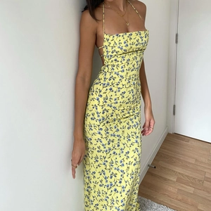 Detail view of the open back design on this yellow floral summer slip dress