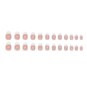 French tip press-on nails with 3D silver bows and pearls on a nude base color