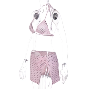Detailed view of pink polka dot bikini set with a matching side-slit swim skirt