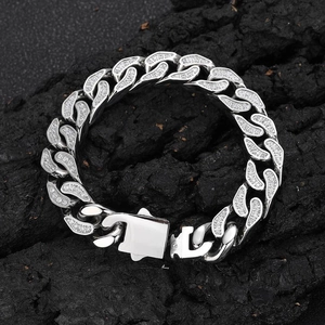 12mm stainless steel Cuban link bracelet with CNC set zircons on dark rock background